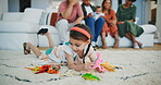 Girl kid, dinosaur toys and floor with playing, development and relax with game in room at family house. Child, plastic reptile and carpet with hands, flooring or animal for fantasy, learning or home