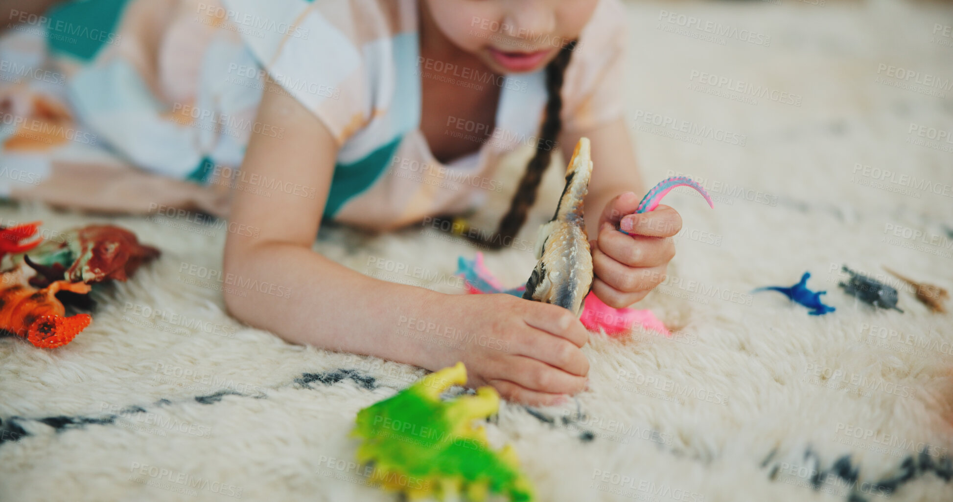 Buy stock photo Girl child, dinosaur toys and floor with playing, development and relax with game in room at family house. Kid, plastic reptile and carpet with hands, flooring or animal for fantasy, learning or home