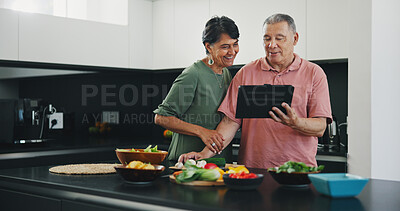 Buy stock photo Senior couple, tablet and recipe for meal, kitchen and cooking together for bonding, smile and support. Happy elderly people, healthy food and diet in retirement, fun and app for meal prep or web