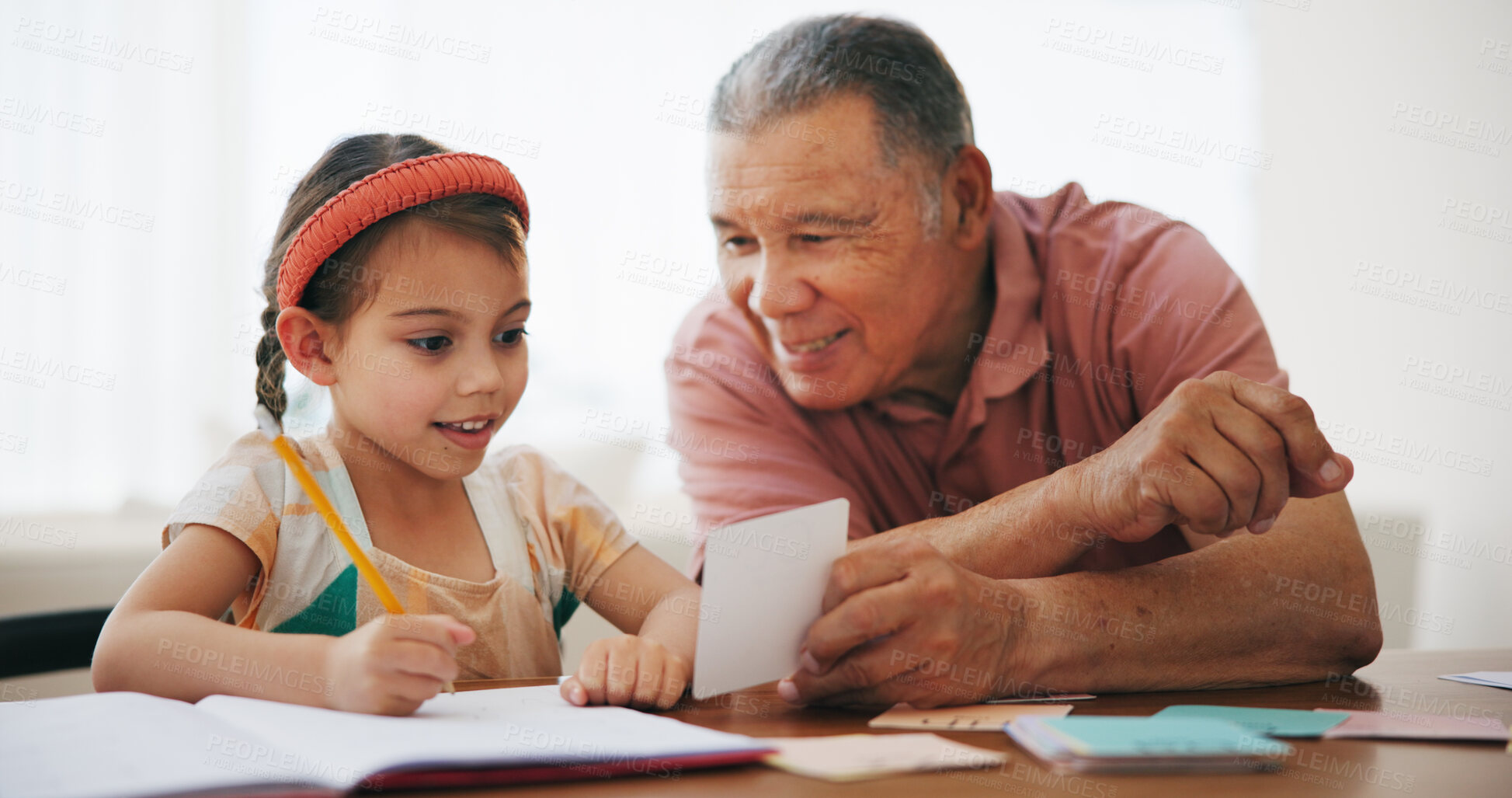 Buy stock photo Child, senior man and learning or reading, book and education at home, drawing and support or paper. Girl, grandfather and notebook or tutoring, assessment and smile for language or math homework