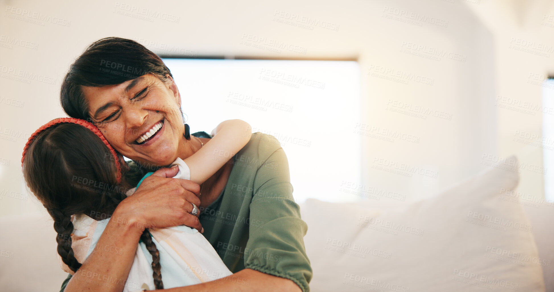 Buy stock photo Grandmother, grandchild and smile in hug, love and bonding in retirement, care and relaxing. Happy mexican people, sofa and welcome in visit, greeting and embrace on couch, gratitude and affection