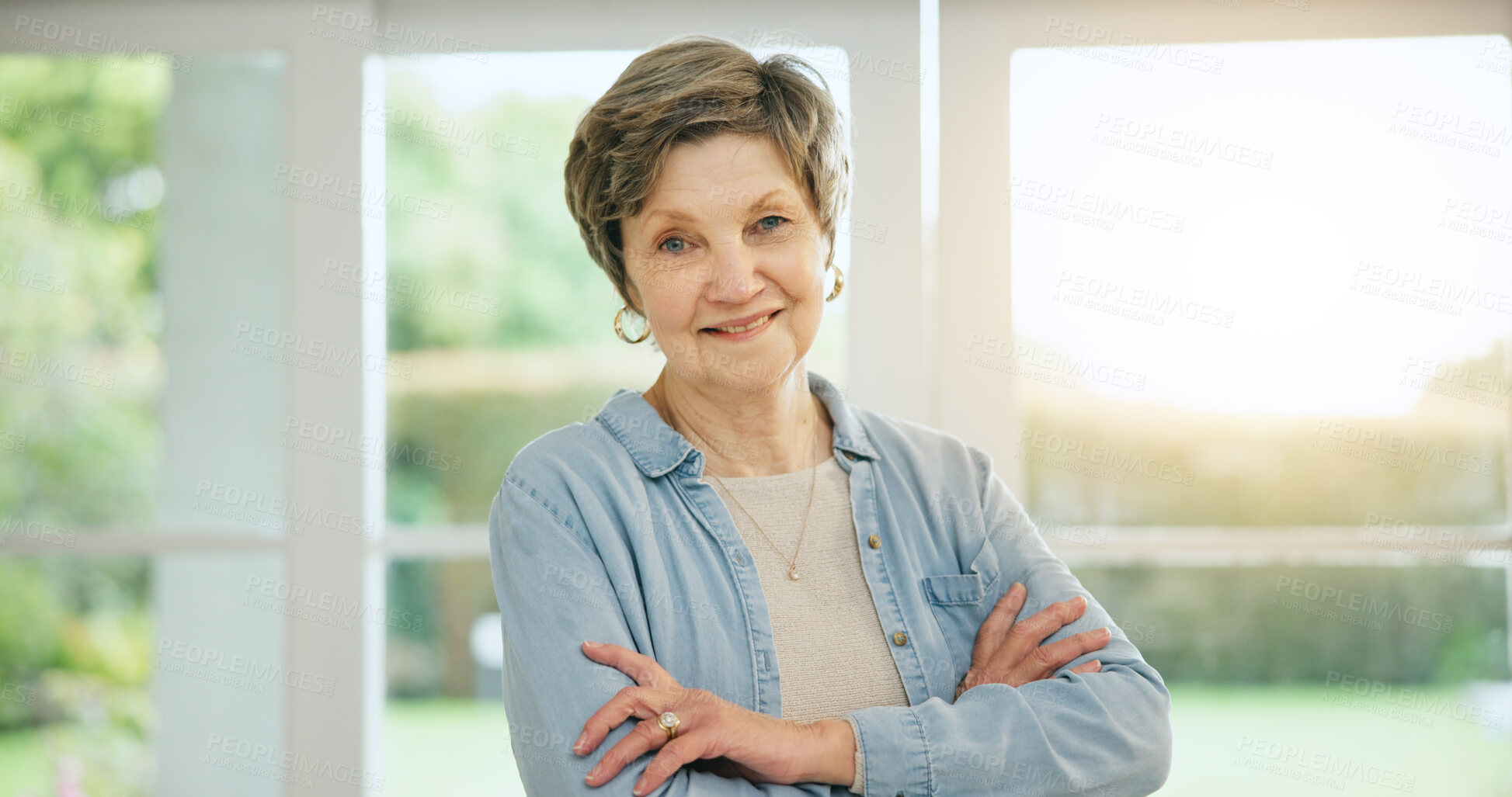 Buy stock photo Senior woman, portrait and arms crossed in retirement, morning and home with happiness and health. Elderly, person and smile on face in house to relax with sunshine in apartment, lounge or vacation