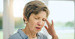 Frustrated senior woman, headache and stress in burnout, anxiety or depression at home. Closeup of mature female person with migraine, pain or sore head in mental health, mistake or fail at house