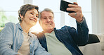 Happy senior couple, selfie and sofa in living room for photography, memory or picture together at home. Mature man or woman smile in relax for photograph, vlog or social media in retirement at house