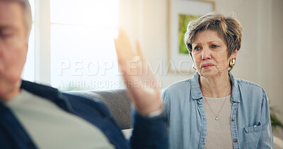 Buy stock photo Senior, couple and divorce with conflict and fight on sofa in living room of home with hand for stop. Elderly, man and woman with argument, upset and frustrated on couch in lounge of house or ignore