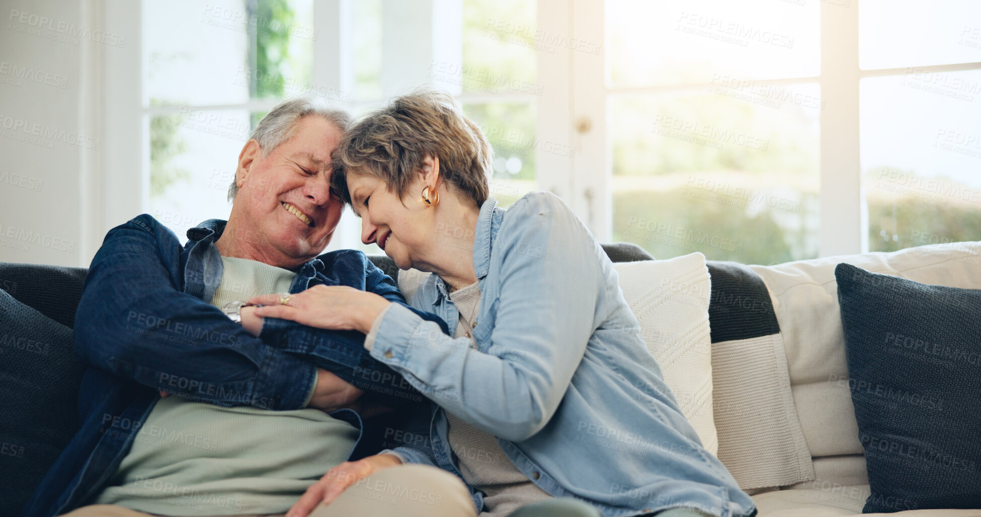 Buy stock photo Love, home and mature couple laughing at funny conversation, retirement joke and smile on living room sofa. Wellness, comedy humour and relax old man, senior woman and elderly marriage people bonding