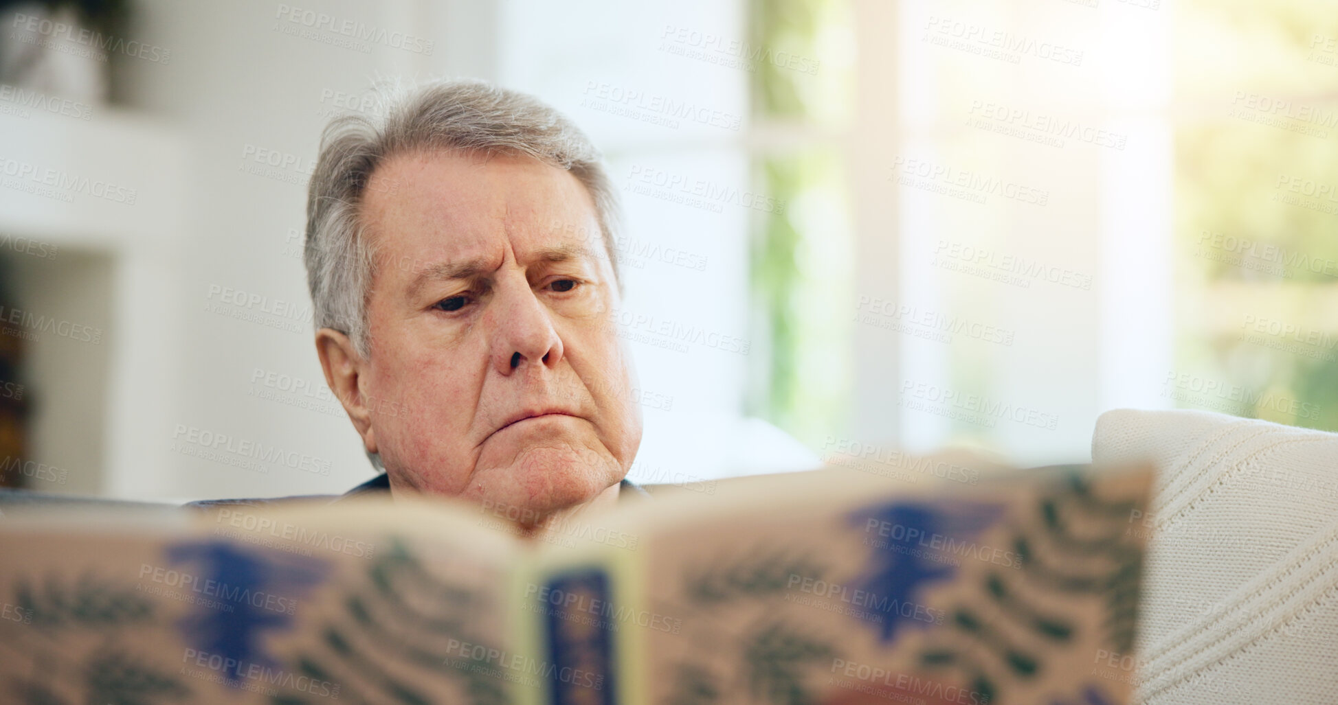 Buy stock photo Home, relax and senior man reading a book, thinking and knowledge with hobby, retirement and serious. Pensioner, apartment and elderly person in a living room, idea and story with novel or literature