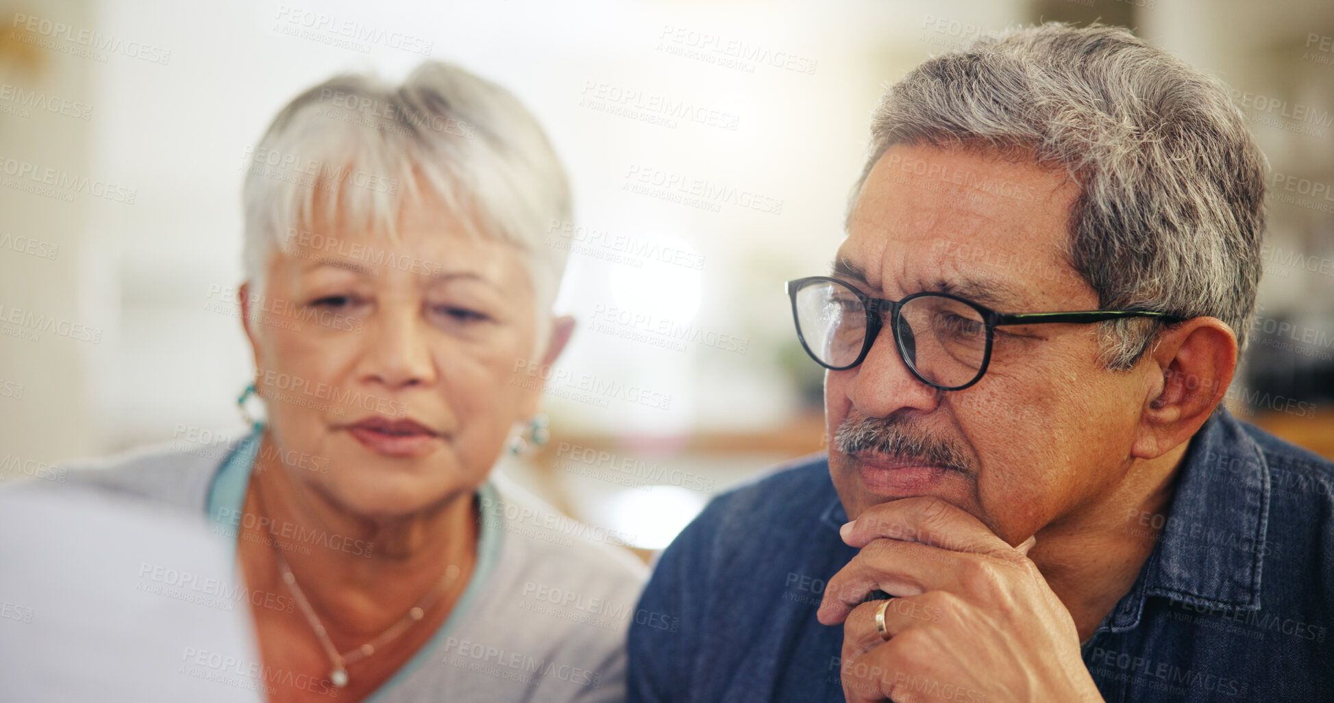 Buy stock photo Senior couple, bills and reading documents in home for budget, planning financial assets and investment. Face of man, woman and thinking of paperwork, taxes or retirement savings for insurance policy