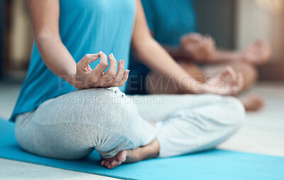 Buy stock photo Shot of a unrecognizable woman engaging in a seated yoga pose with her legs crossed