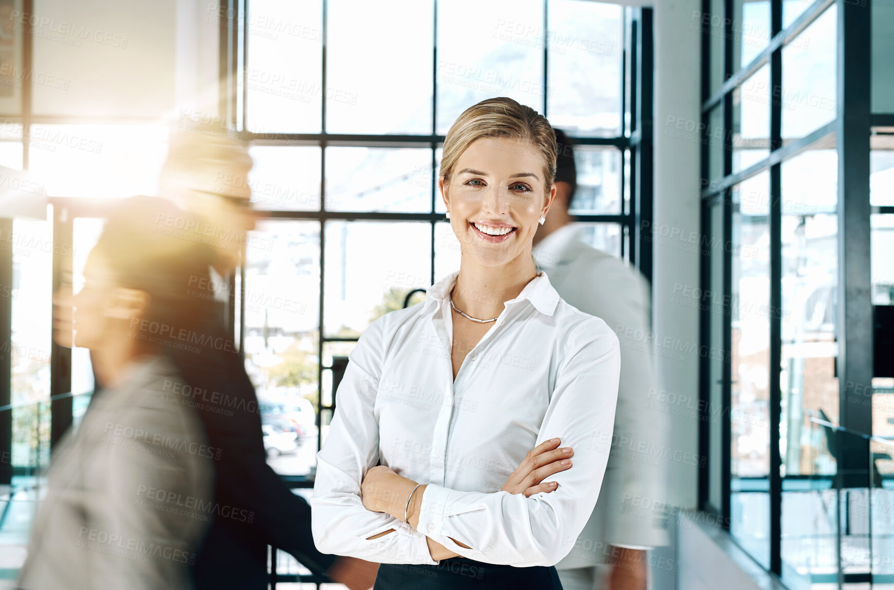 Buy stock photo Shot of an confident and attractive businesswoman standing and smiling in the office with her arms folded