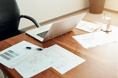 Buy stock photo Cropped shot of paperwork and a laptop on a desk in an office