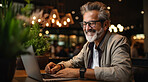 Portrait, man and Business person with laptop, cafe and typing. Sitting, typing  and online reading. Face, male or leader in a restaurant, pc or technology with education, email and freelancer.