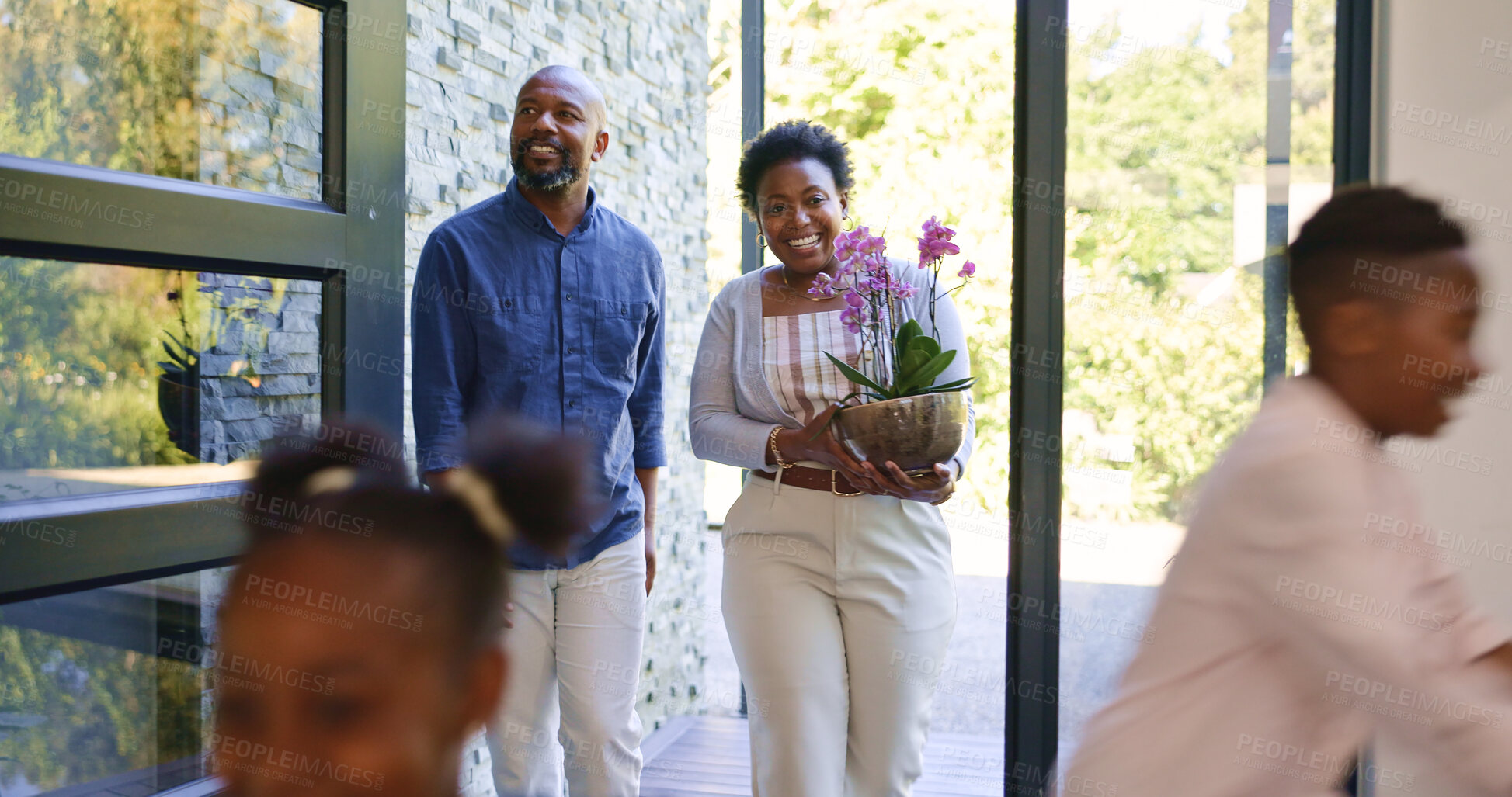 Buy stock photo Happy family, children and walk by door in new home in excitement for real estate, property investment or flower plant. Black man, woman and kids with motion blur for relocation, moving or together