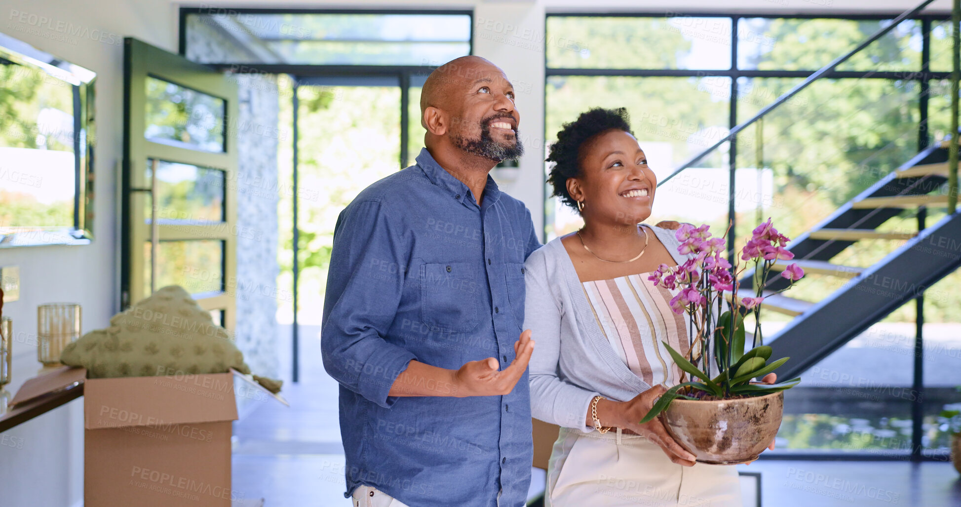 Buy stock photo Couple, flowers and happy in new home or real estate with property investment, fresh start and support. Black people, man and woman with pot plant for moving, mortgage and excited for achievement