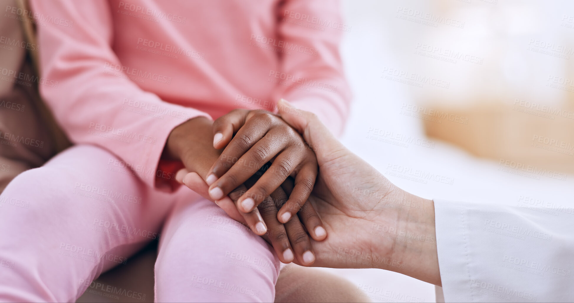 Buy stock photo Closeup, holding hands and doctor with girl, healthcare and wellness with comfort, diagnosis and support. People, medical and professional with a patient, compassion and empathy with paediatrician