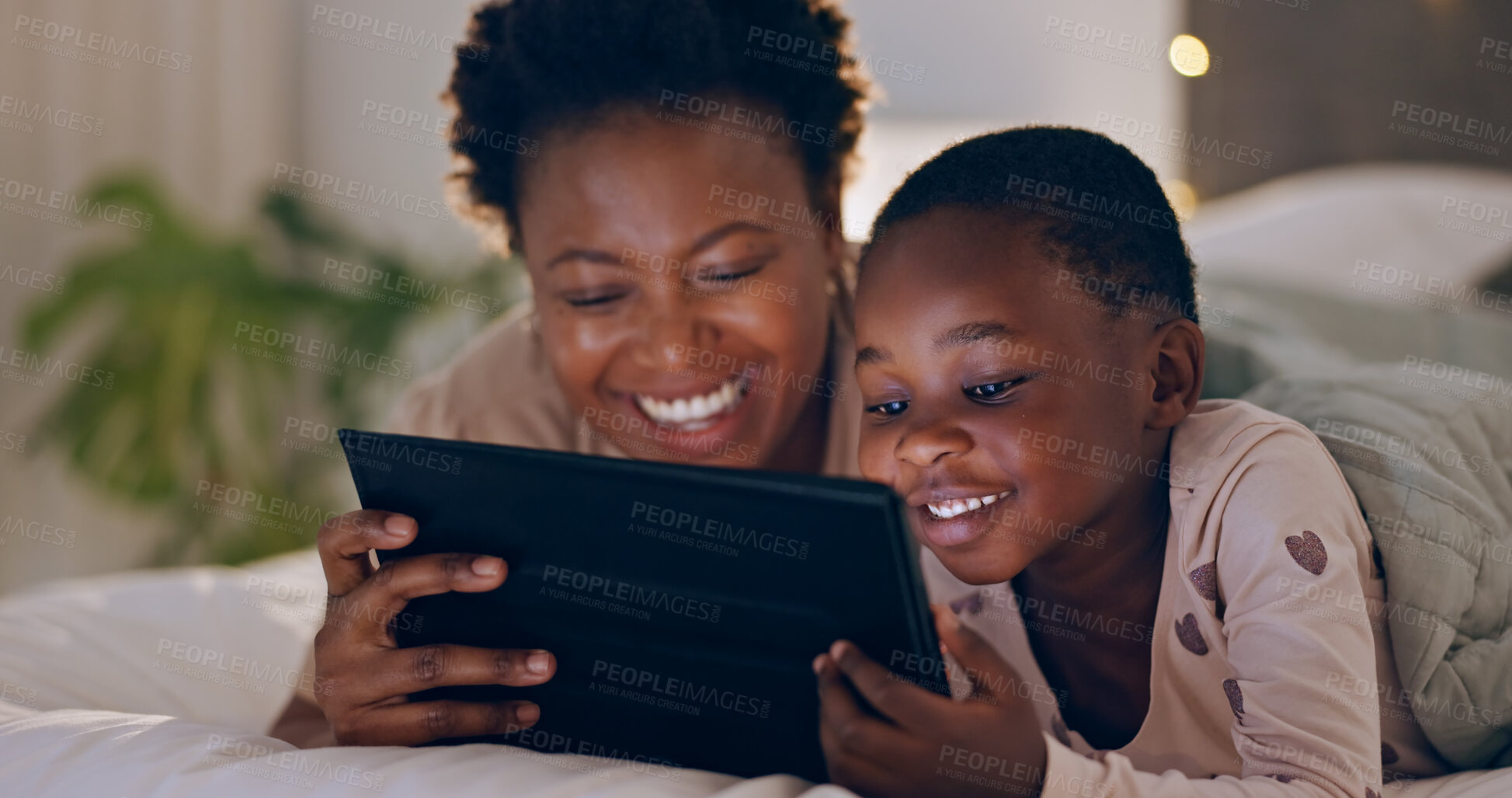 Buy stock photo Mother, child and tablet in bedroom at night watching cartoons in bed with technology and laugh. Happy, enjoying and online for videos, digital and internet in home streaming or bonding together
