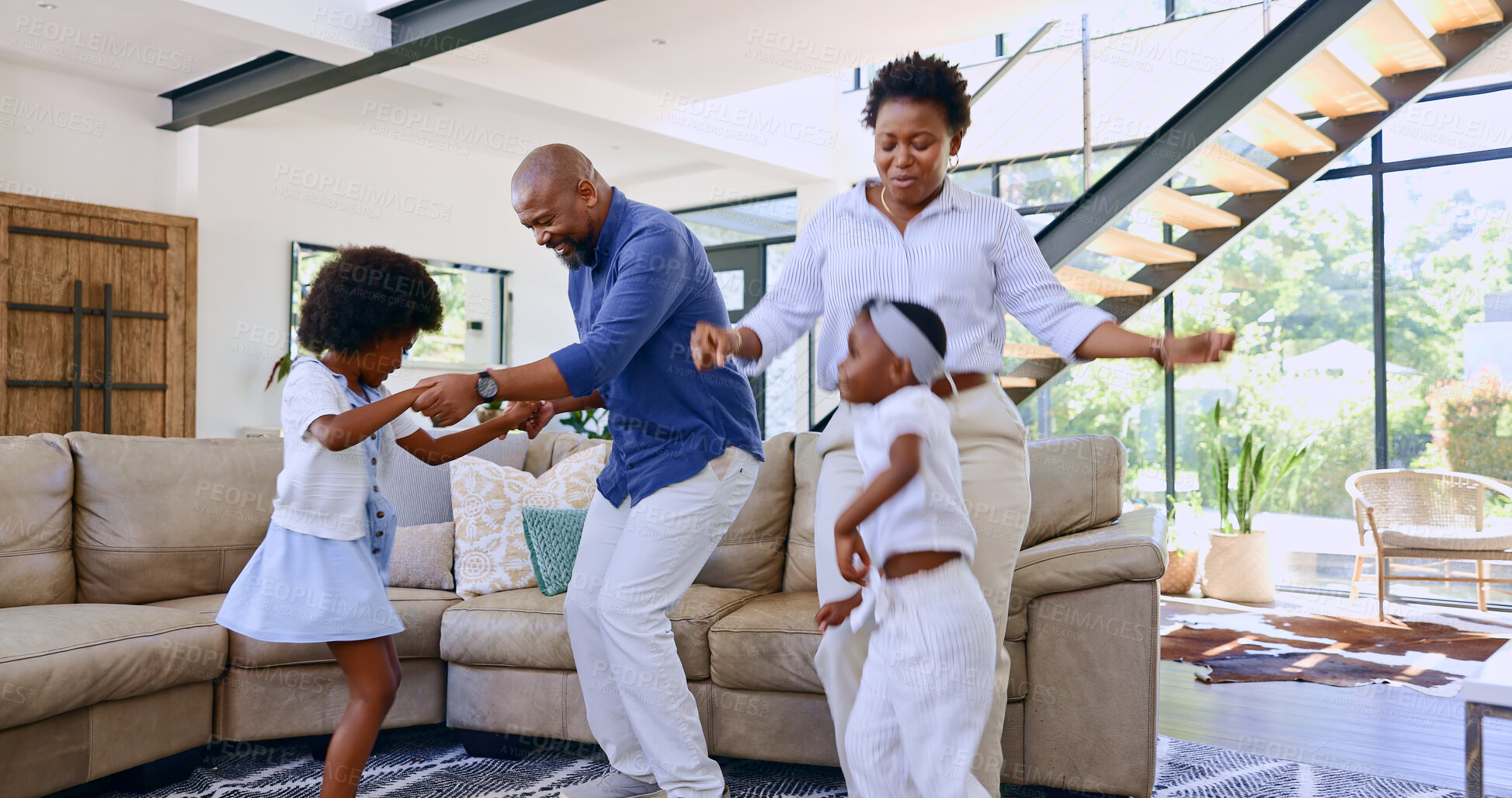 Buy stock photo Black family, parents and children with dancing in living room for love, relax and bonding with music and movement. People, man or women with having fun, dancer and teaching steps in lounge of house
