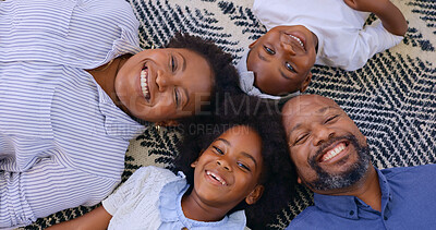 Portrait, top view and happy family on a floor with love, bond and fun at home together. Face, smile and above kids with parents in a living room with support, security or trust, weekend or freedom
