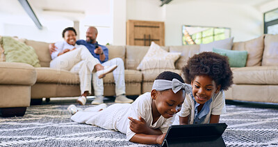 Family, children and tablet on floor watching cartoons, parents and living room couch. Screen time, relaxing and streaming while bonding together as siblings, technology and childhood memories