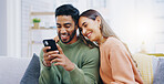 Couple, living room sofa and texting with phone, smile and click for contact, meme and notification in home. Man, woman and happy with smartphone, reading and app for social network, video and relax