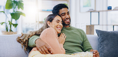 Buy stock photo Love, hug and couple on watching tv on a sofa with popcorn for movie, film or streaming show at home. Relax, television and people embrace in a living room with cinema snack for comedy or series