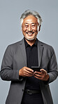 Senior asian man, portrait and phone for social media app, internet and website on color background mockup. Face, smile and happy pensioner with mobile technology for influencer blog post in house with bokeh background