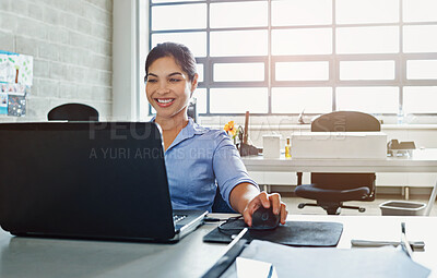 Buy stock photo Shot of a young businesswoman using a laptop at work