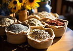 Closeup, seeds and sunflower on table from farming, agriculture and environment harvest. Organic food, plantation and nutritious produce in bags for service industry, agribusiness and sustainability