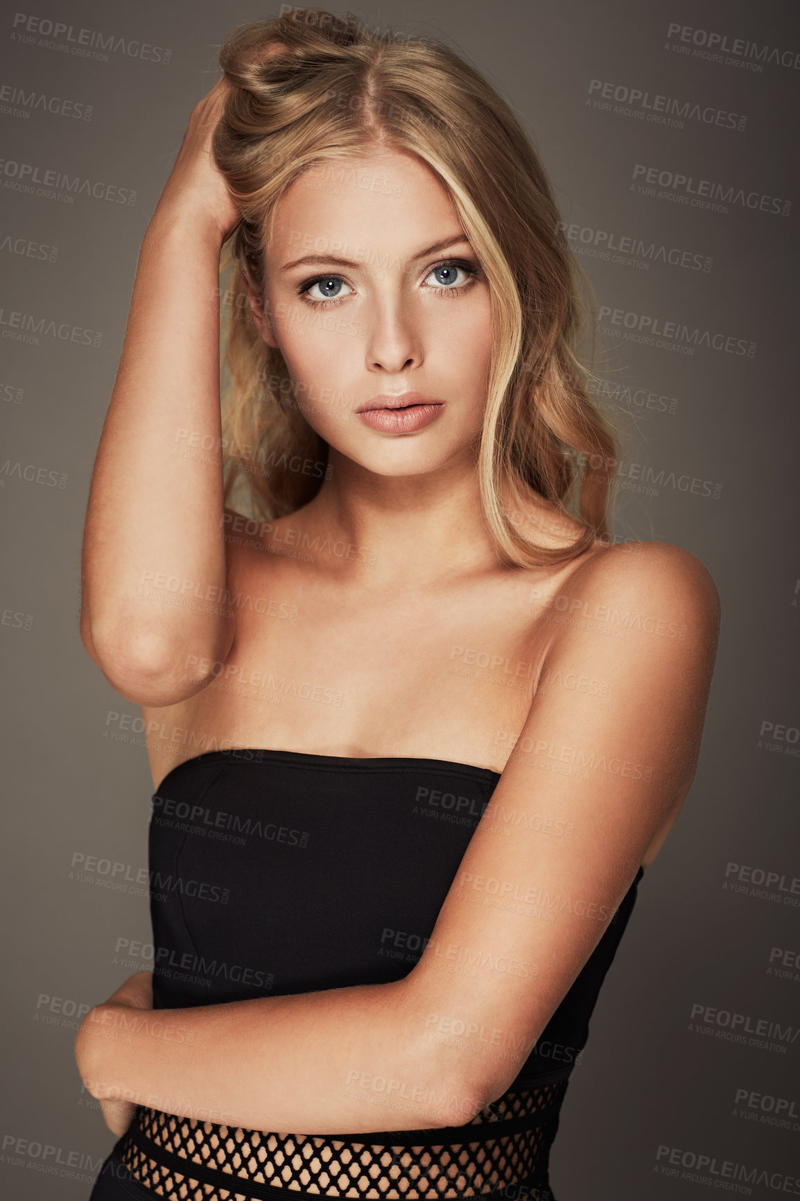 Buy stock photo Portrait, beauty and hair with a natural woman in studio on a gray background for aesthetic wellness. Salon, skincare or haircare and a serious young model looking confident with a cosmetic routine