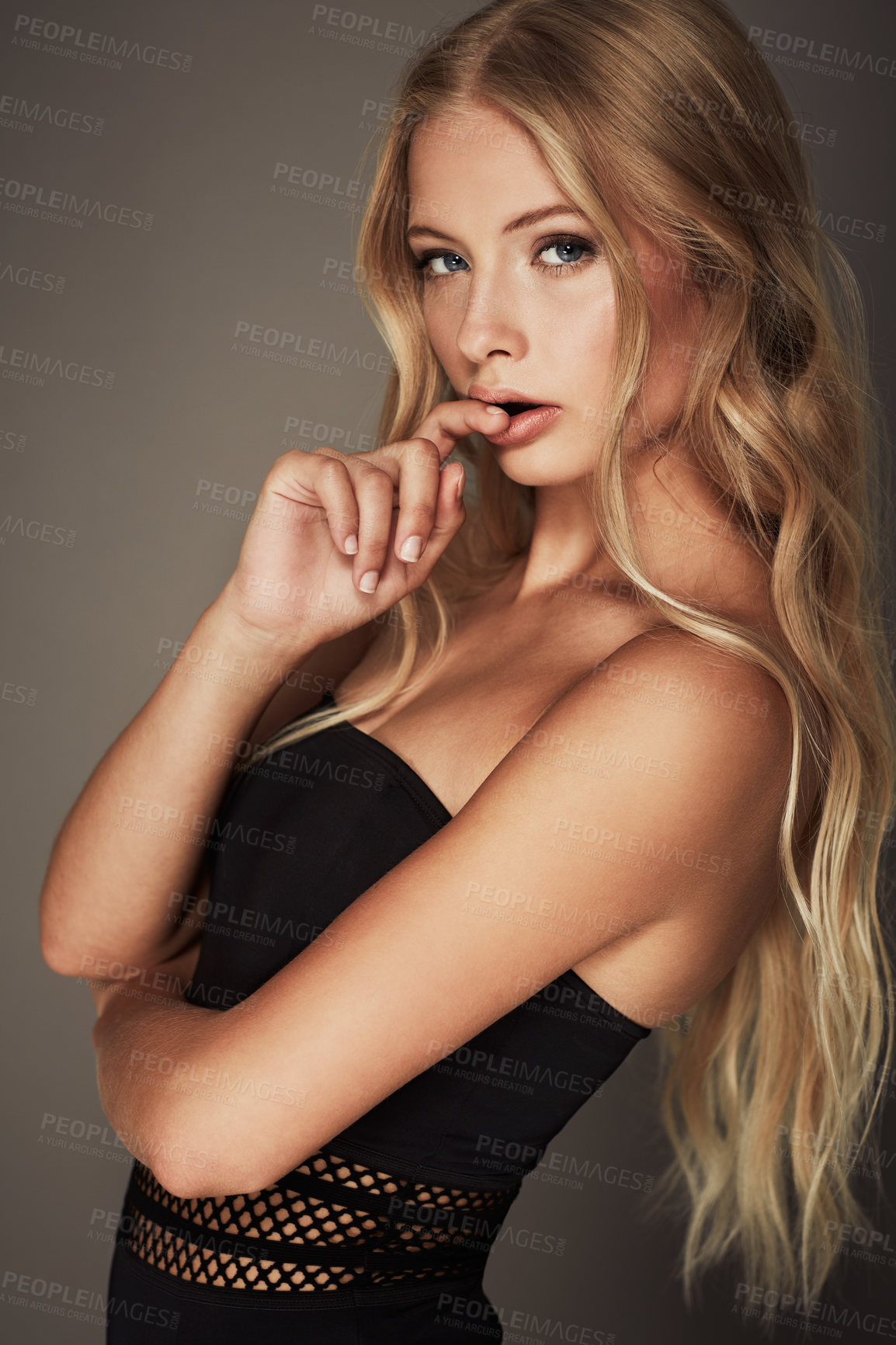 Buy stock photo Face, beauty and portrait of a seductive woman in studio with makeup, cosmetics and long hair. Headshot of female aesthetic model with natural glow, luxury skincare and sexy pose on a grey background