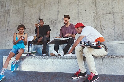 Buy stock photo Shot of a group of skaters having lunch together