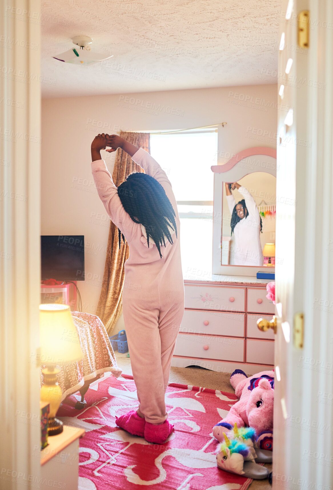 Buy stock photo Rearview shot of an unrecognizable little girl stretching in her bedroom