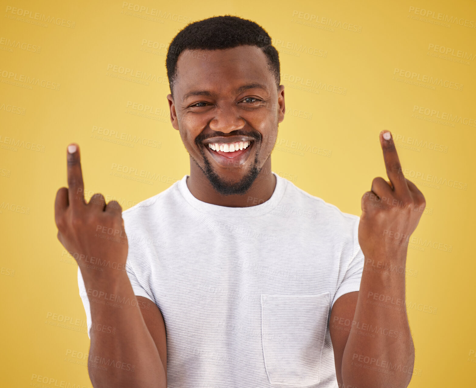 Buy stock photo Happy, middle finger and portrait of black man in studio with rude, insulting and bad sign. Emoji, symbol and face of person with hand gesture on yellow background for joke, rebel attitude and laugh