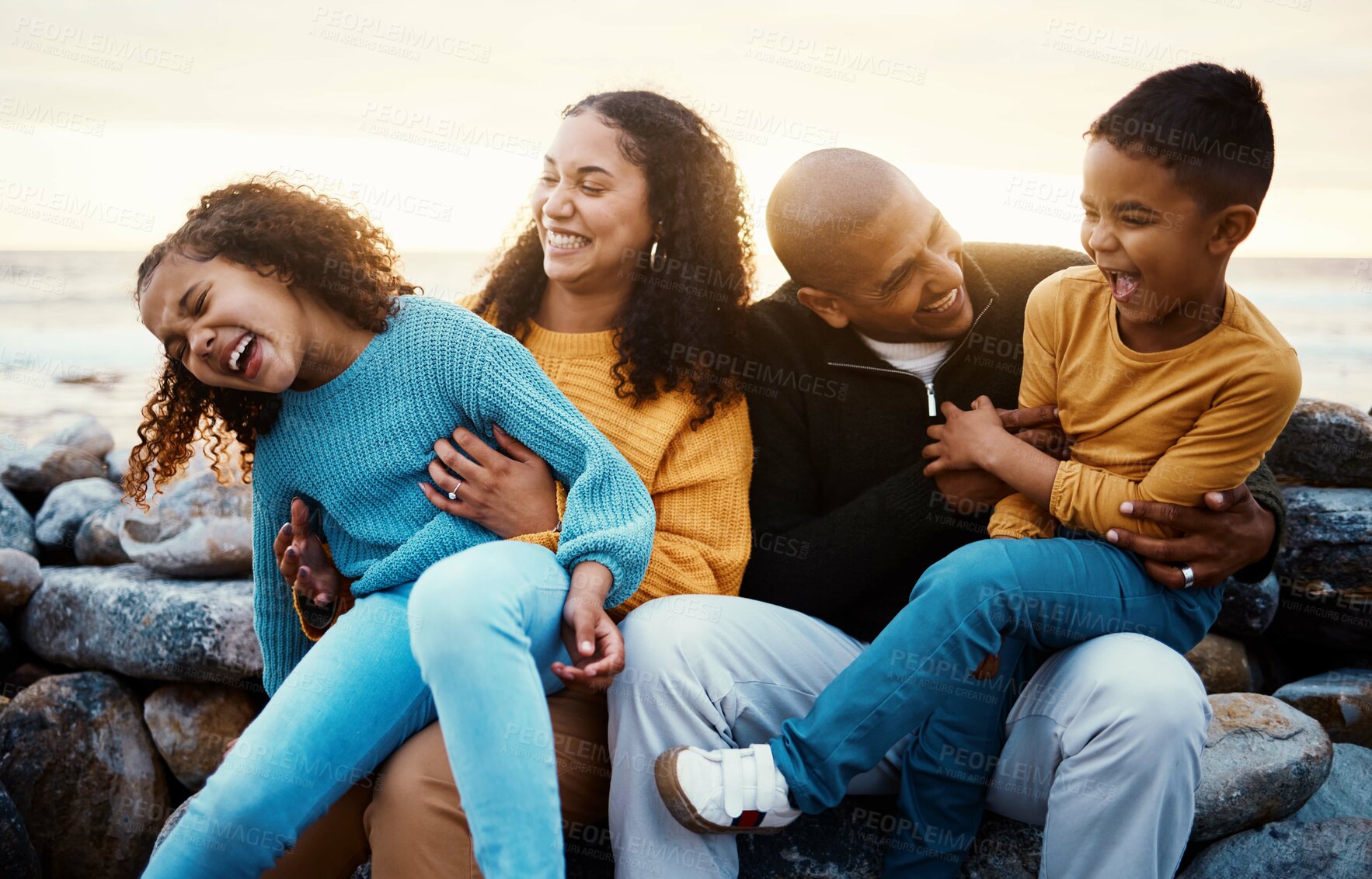 Buy stock photo Laughing, family and relax at beach on vacation, holiday or trip at sunset outdoors. Love, care and happy, bonding and funny children, father and mother with laughter for tickling, joke or comedy.