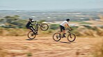 Mountain bike, men and race with speed, dirt and nature in summer with wheelie, extreme sport and motion blur. Friends, bicycle and outdoor challenge for fast workout, training and exercise in summer