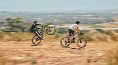 Buy stock photo Mountain bike, men and race with speed, dirt and nature in summer with wheelie, extreme sport and motion blur. Friends, bicycle and outdoor challenge for fast workout, training and exercise in summer