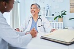 Happy doctor, patient and talking at consultation in hospital with a woman for medical advice. Health care worker and person for conversation, results and communication for wellness and health