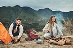 Couple, camping and pitch tent in nature for vacation, holiday and travel together. Campfire, man and woman outdoor in preparation for adventure, hiking and trekking in the countryside for freedom