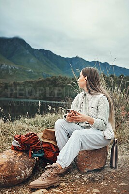 Buy stock photo Camping, phone and woman relax in nature with social media, freedom or outdoor peace. Hiking, break and female explorer with smartphone, app or chat while chilling at forest lake and enjoying scenery