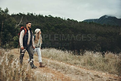 Buy stock photo Couple walking, hiking and nature with travel, mountain and backpacking with wilderness and explore outdoor. People holding hands, adventure and holiday with date, environment and trekking path