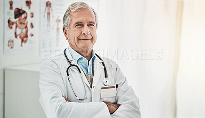 Buy stock photo Portrait of a happy mature doctor posing with his arms crossed in his consultation room