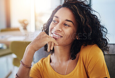 Buy stock photo Cropped shot of an attractive young woman looking thoughtful while relaxing at home on the weekend