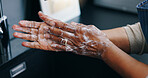 Person, soap and washing hands for hygiene, germ or bacteria removal by tap or sink at home. Closeup of palm in skincare, protection or soapy skin for cleaning, dirt or disinfection by basin at house