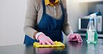 Woman, hands and cleaning table in kitchen for housekeeping, hygiene or sanitary surface at home. Closeup of female person, maid or cleaner wiping furniture for disinfection, germ or bacteria removal