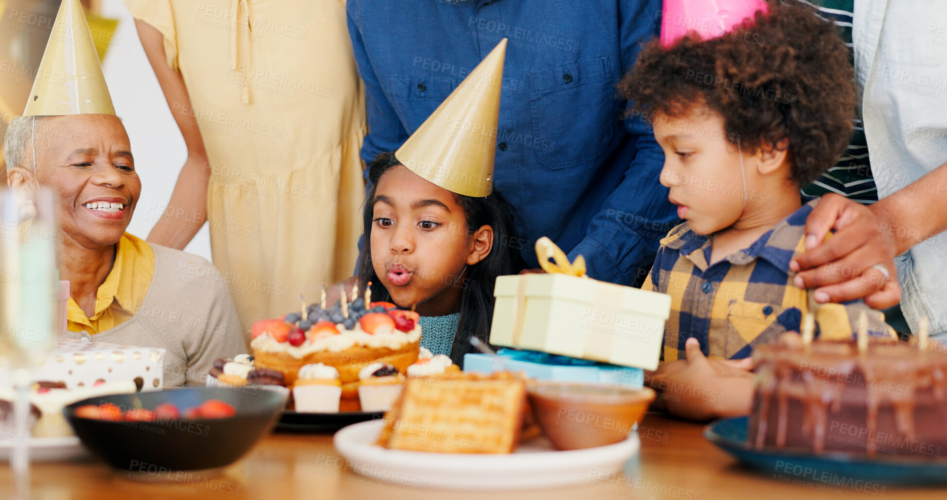 Buy stock photo Happy birthday, wish and cake in celebration with family for party, holiday or special day at home. Excited little girl or child blowing candles in growth, love or care for event, bonding at house