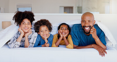 Buy stock photo Happy, portrait and children with parents in bed of modern home for bonding together with love. Smile, fun and young interracial man and woman laying and relaxing with kids in bedroom of family house