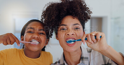 Portrait, bathroom and mother brushing teeth with child for oral health and wellness at home. Bonding, hygiene and young mom and girl kid with morning dental care routine together at house in Mexico.