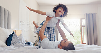 Buy stock photo Happy father, child and playing on bed for bonding, holiday or fun weekend together in morning at home. Dad lying, lifting or kid flying in bedroom for love, care or support in embrace at house