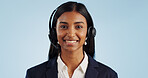 Happy woman, portrait and headphones for call center or telemarketing against a blue studio background. Face of female person, consultant or agent smile with mic for online advice on mockup space