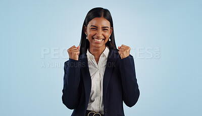 Winner, excited or happy woman in celebration for a business deal isolated on blue background. Wow, goals or proud Indian lady with smile, victory success or reward in entrepreneurship or studio